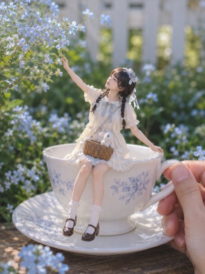 Miniature Woman on a Teacup